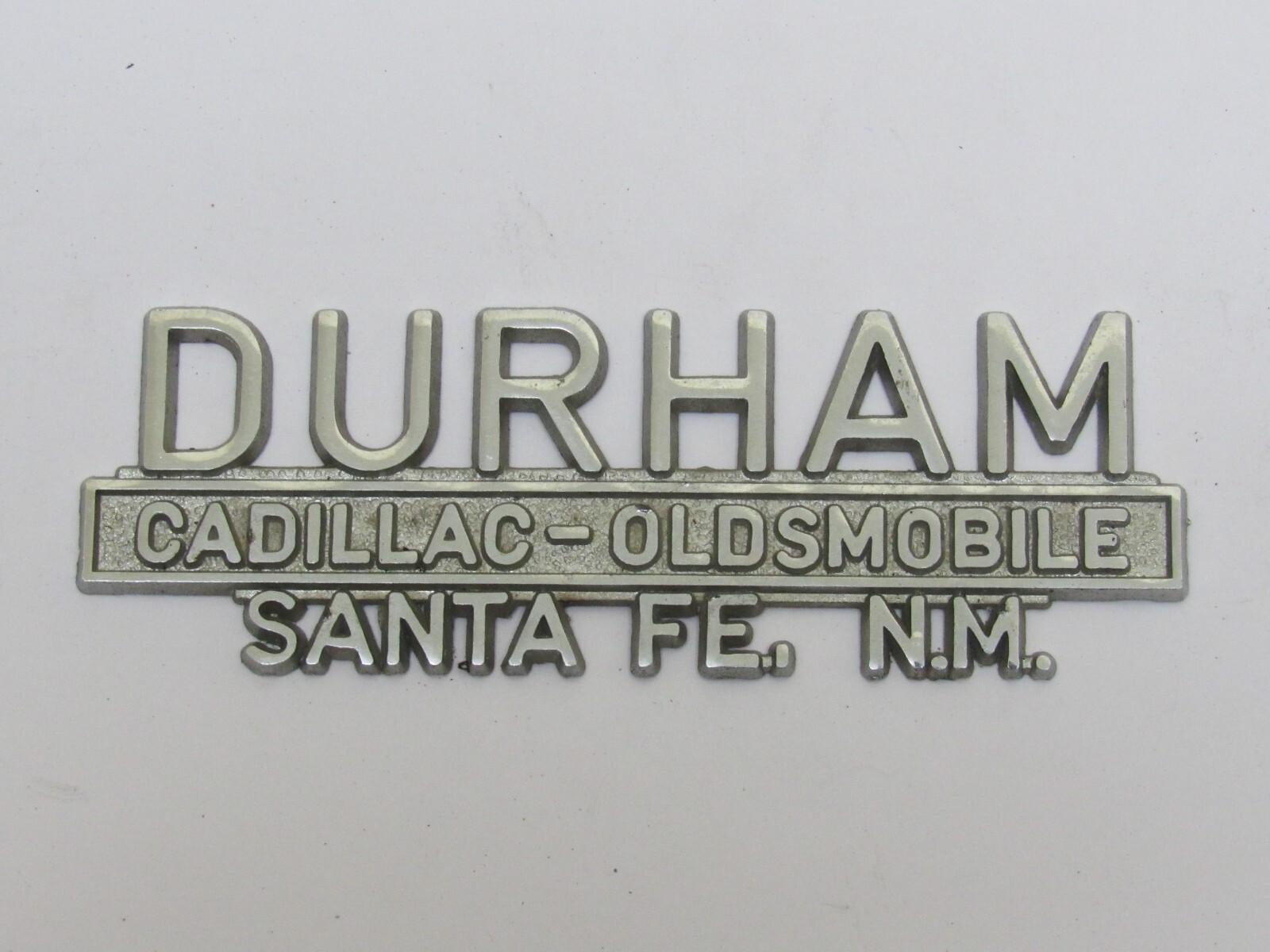 Vintage Durham Olds-Cadillac Santa Fe New Mexico Metal Dealer Badge Emblem Tag